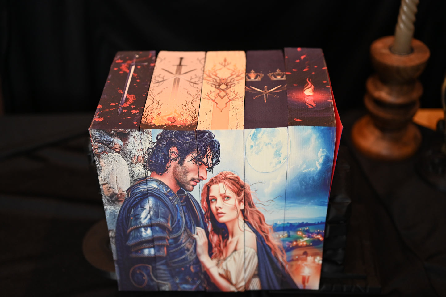 Set Din sânge și cenușă - 5 volume cu printed edges, prezentând o ilustrație detaliată cu un bărbat în armură și o femeie cu păr roșcat și ochi verzi, sub o lună plină, pe un fundal de peisaj nocturn.