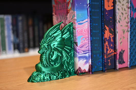 suport de carti verde smarald intruchipand un dragon, care sustine carti cu printed edges