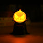 decoratiune fantasy dovleac de halloween luminos, asezat peste o lumanare LED